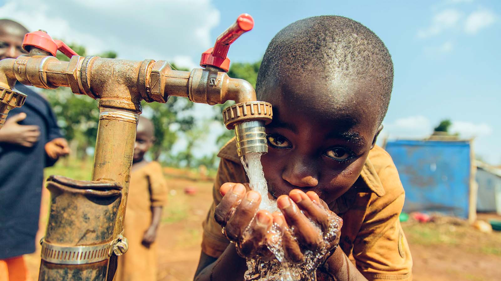 Child drinking water from a faucet